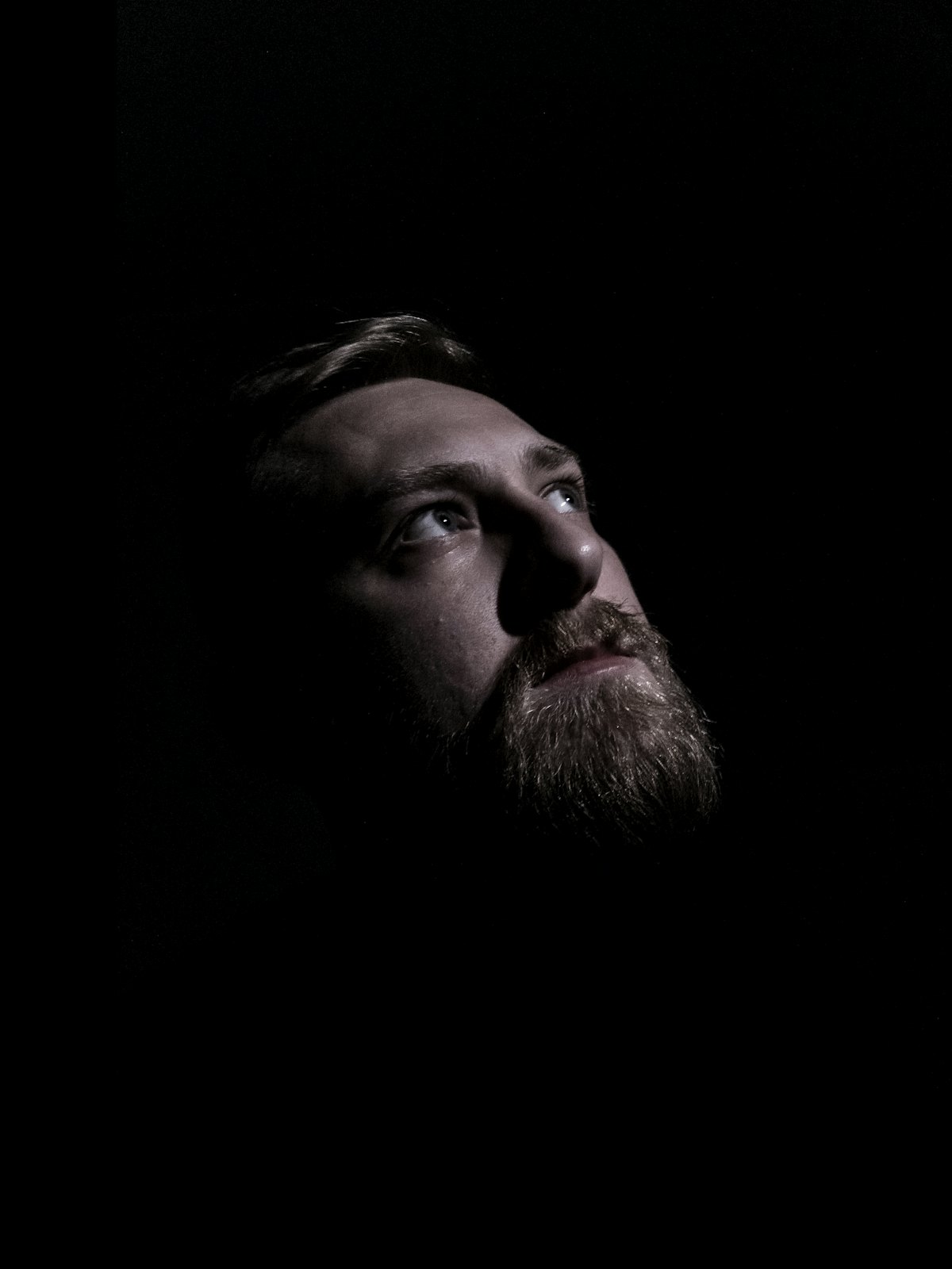 Athlete looking up and breathing in a dark room