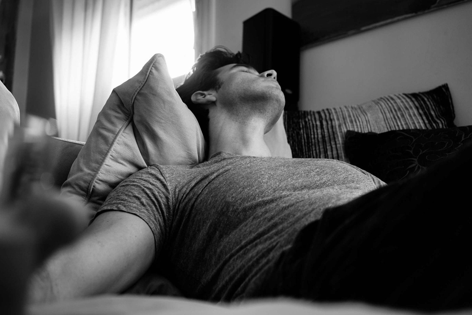 Man asleep in bed, black and white