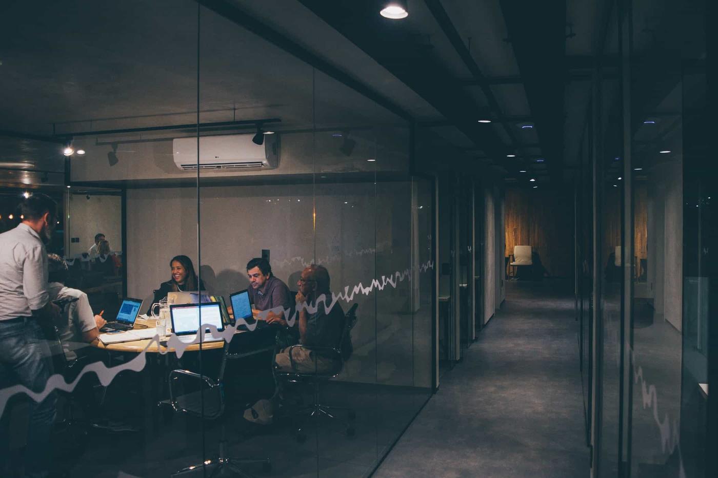 Evening in an office with a glass-walled meeting room